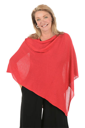 Woman wearing a metallic red poncho against a white background