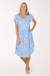 Woman wearing a blue patterned dress on a white background