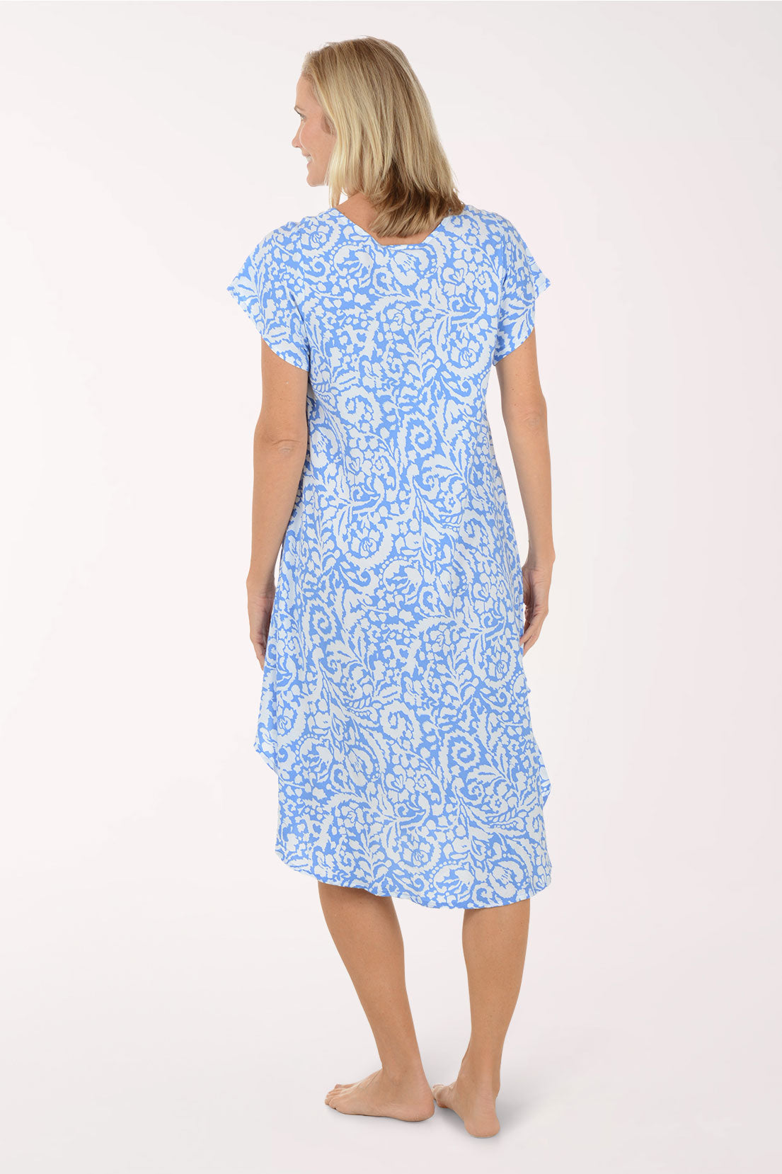Woman wearing a blue patterned dress on a white background