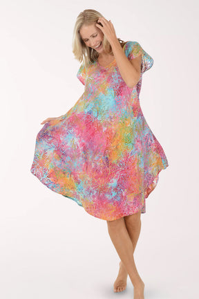 Woman wearing a colorful dress on a white background