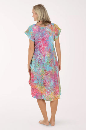 Woman wearing a colorful dress on a white background