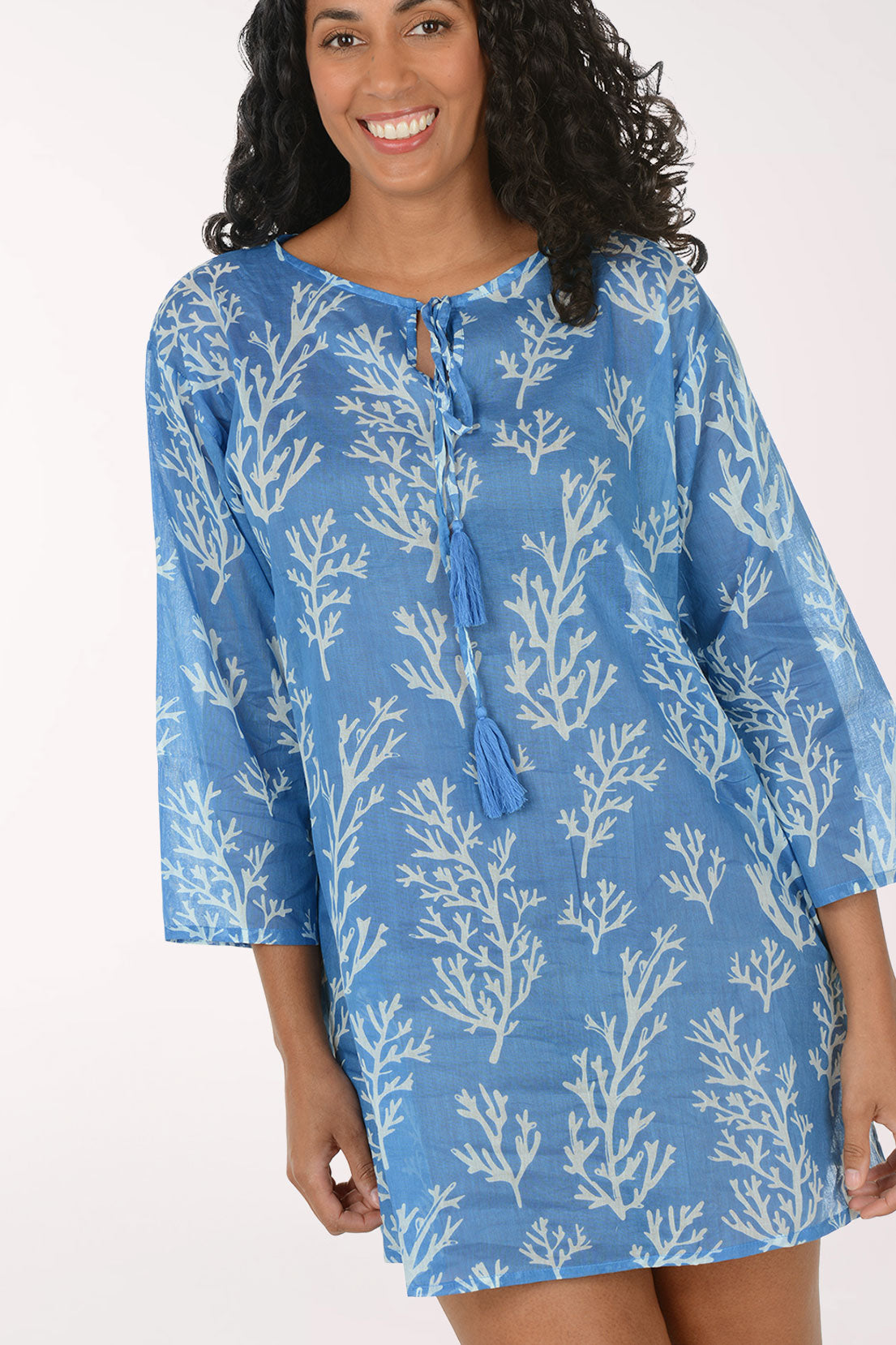 Woman wearing a blue floral dress on a white background