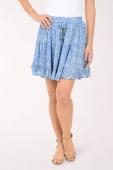 Person wearing a blue patterned skirt on a white background