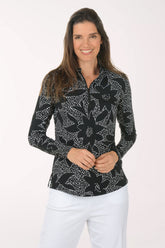 Woman wearing a black floral patterned shirt on a white background