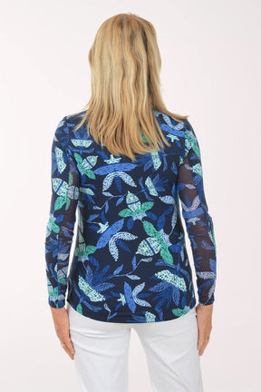Woman wearing a blue floral patterned shirt on a white background