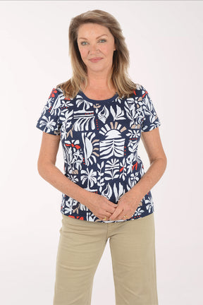 Woman wearing a navy blue t-shirt with a colorful leaf pattern on a white background