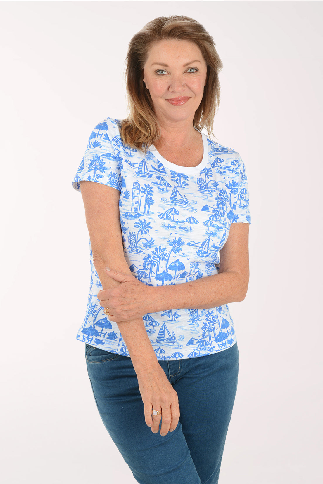 Woman wearing a blue and white patterned shirt on a white background