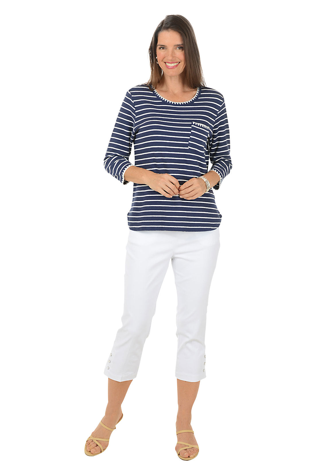 Woman wearing a navy and white striped shirt with white pants on a white background