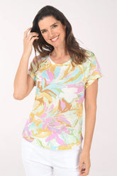 Woman wearing a colorful floral-patterned shirt on a white background