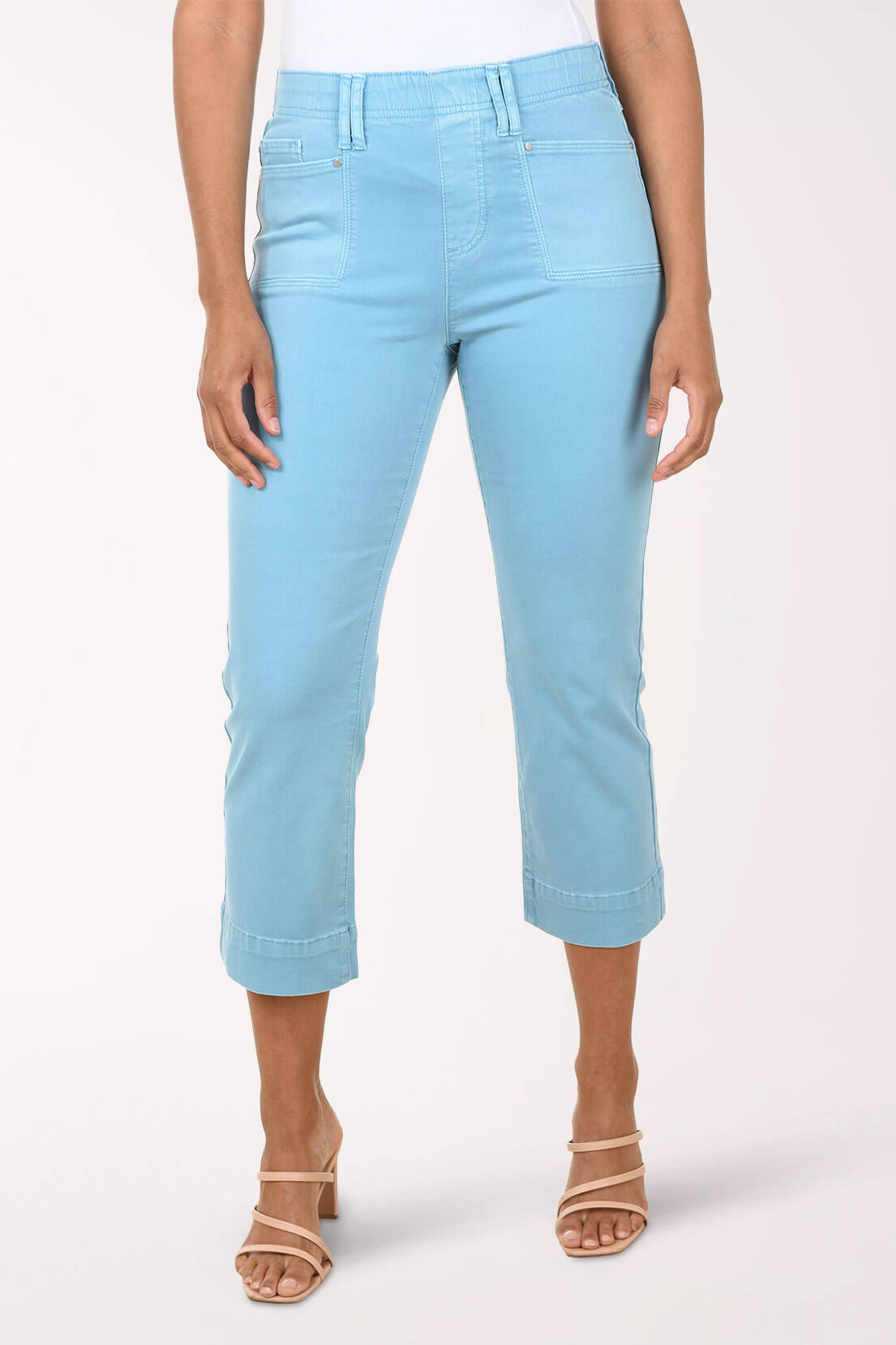 Light blue jeans worn by a person on a white background