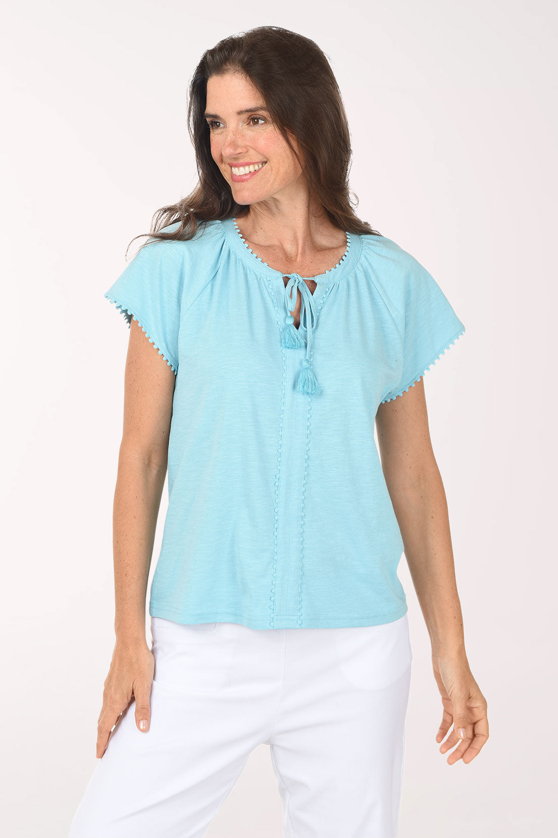 Woman wearing a light blue blouse with a white background