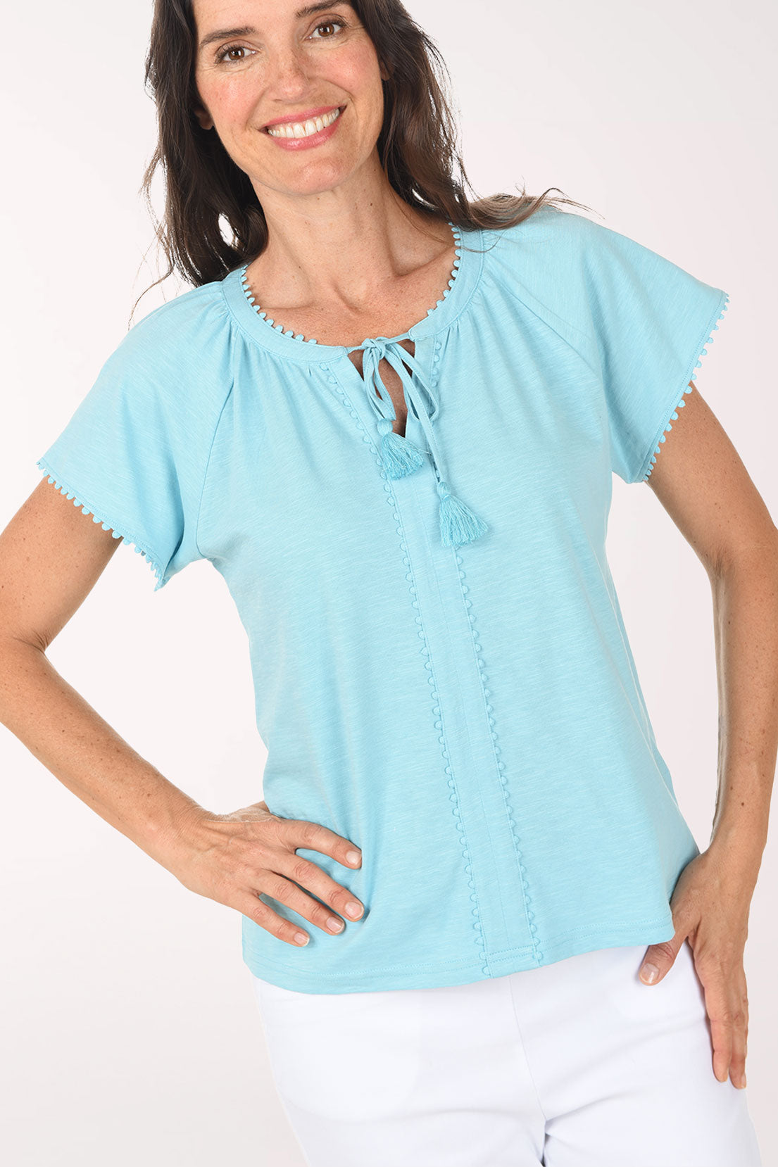 Woman wearing a light blue blouse with a white background