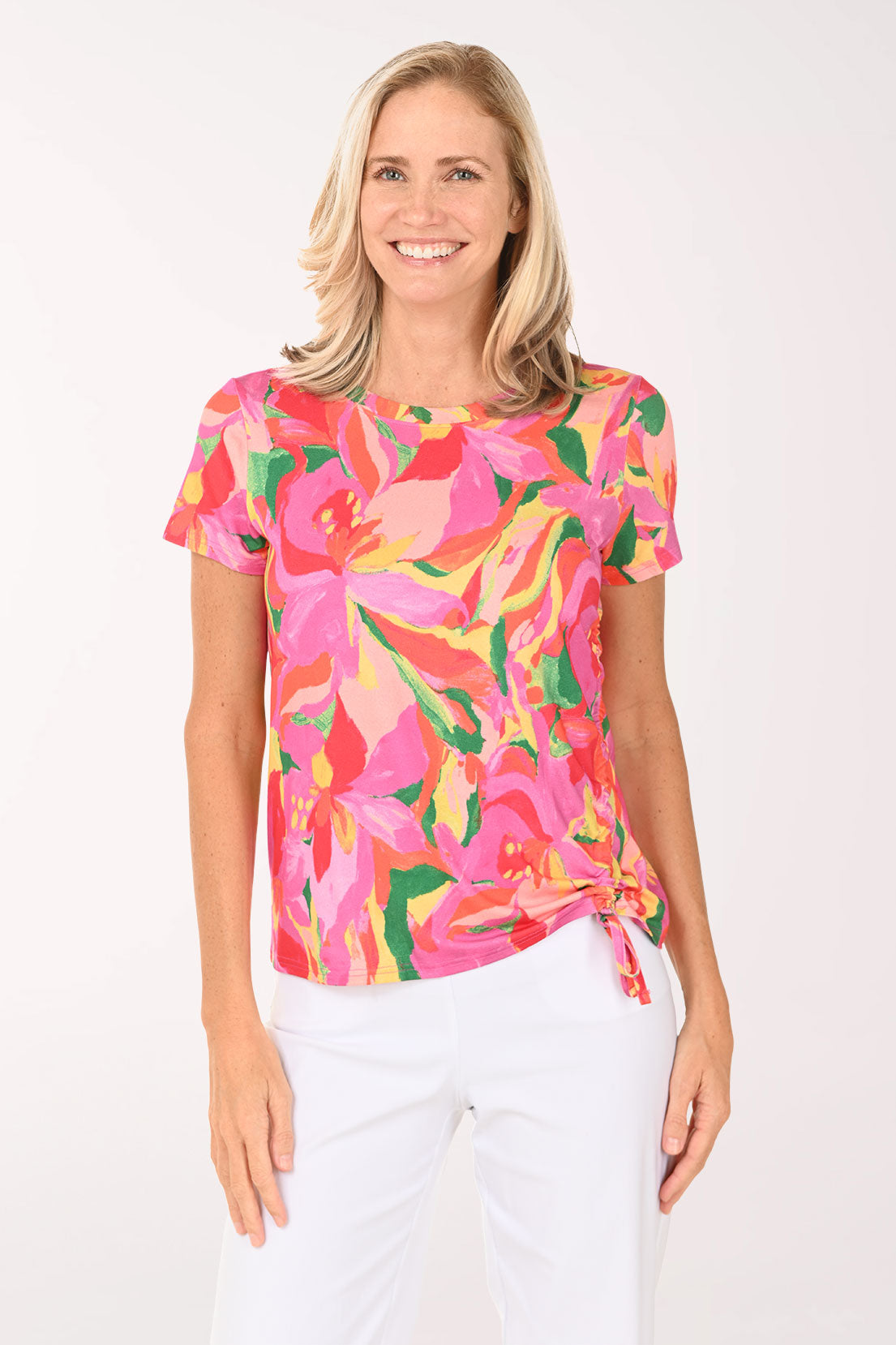 Woman wearing a colorful floral top on a white background