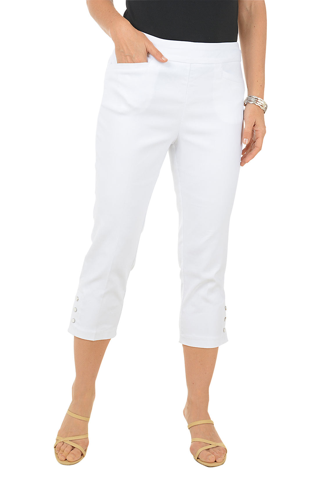 White capri pants worn by a person on a white background