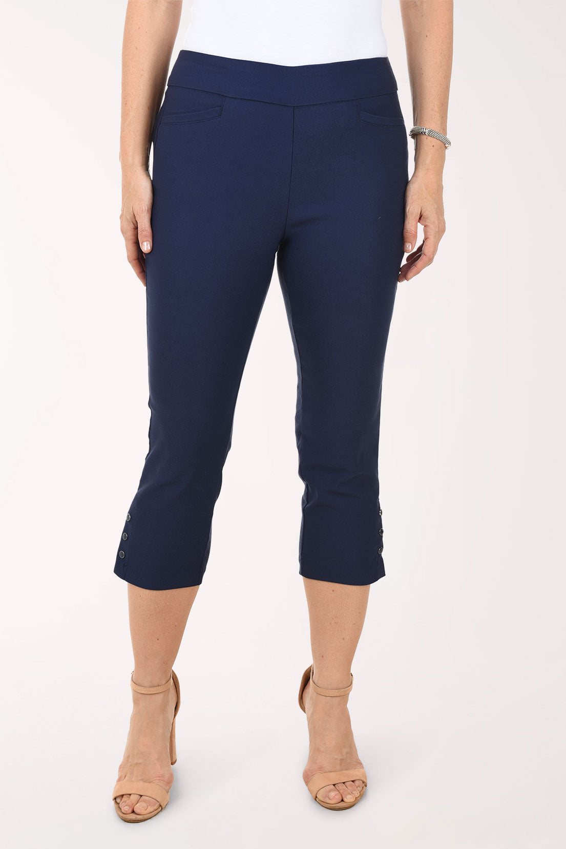 Navy blue capri pants worn by a person on a white background
