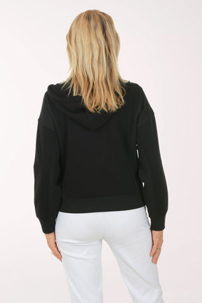 Woman wearing a black hoodie with a zipper on a white background