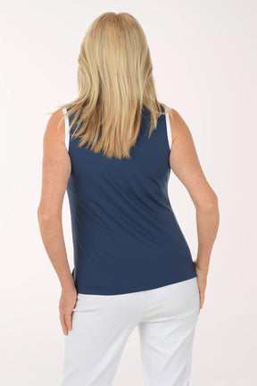 Woman wearing a navy sleeveless top with a blue zipper on a white background