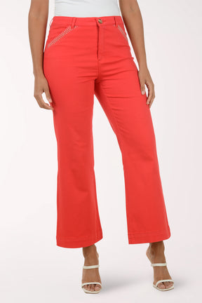 Red pants worn by a person on a white background