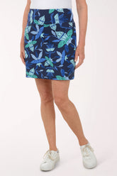 Person wearing a blue patterned skirt on a white background
