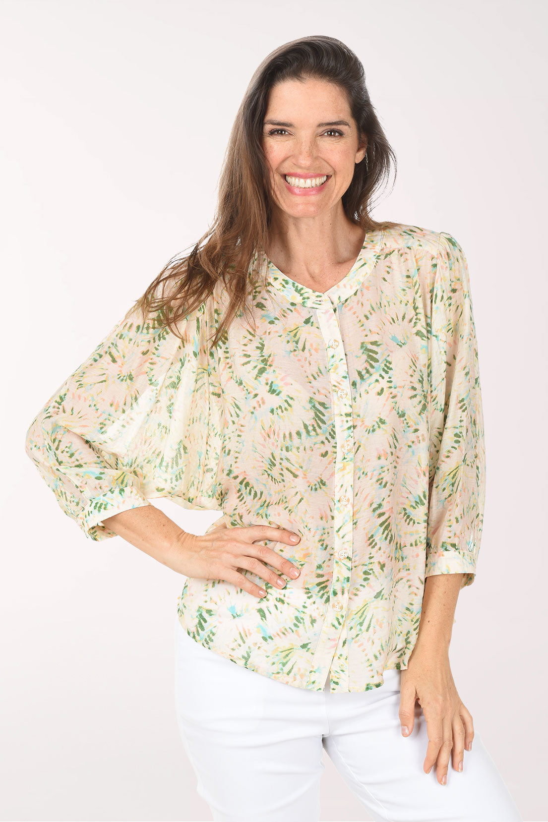 Woman wearing a floral blouse with a white background