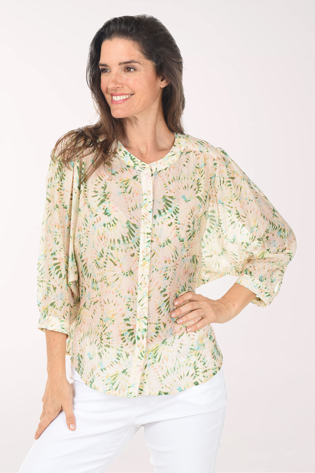 Woman wearing a floral blouse with a white background