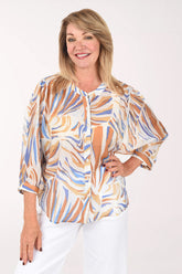 Woman wearing a patterned blouse with a white background