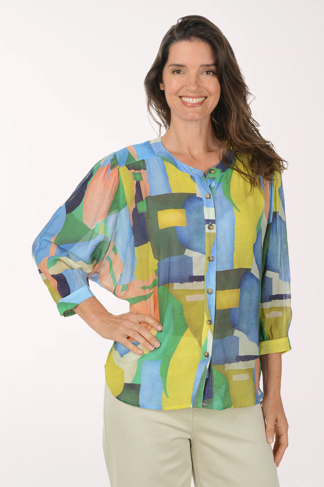 Woman wearing a colorful abstract patterned shirt on a white background