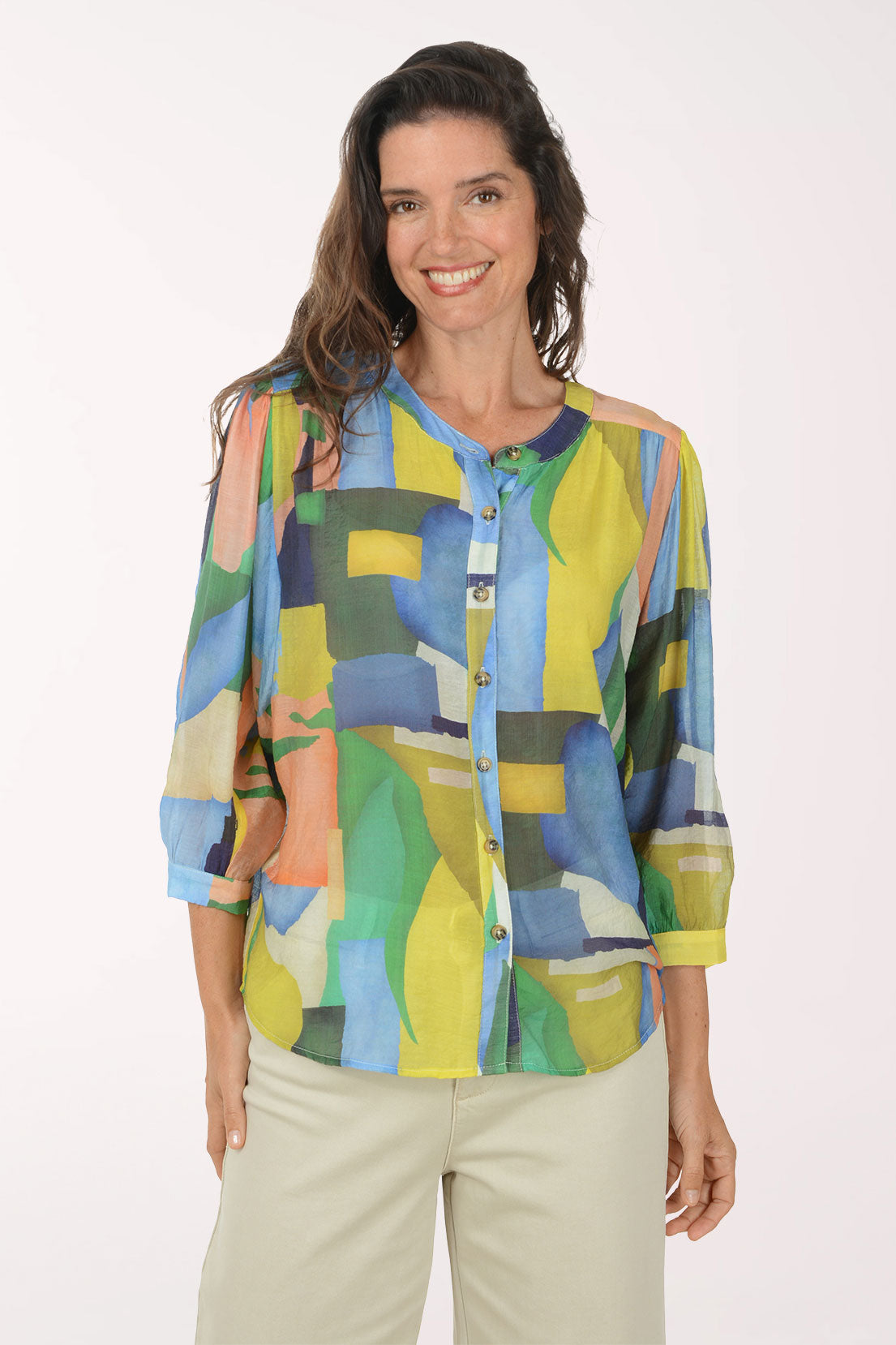 Woman wearing a colorful abstract patterned shirt on a white background