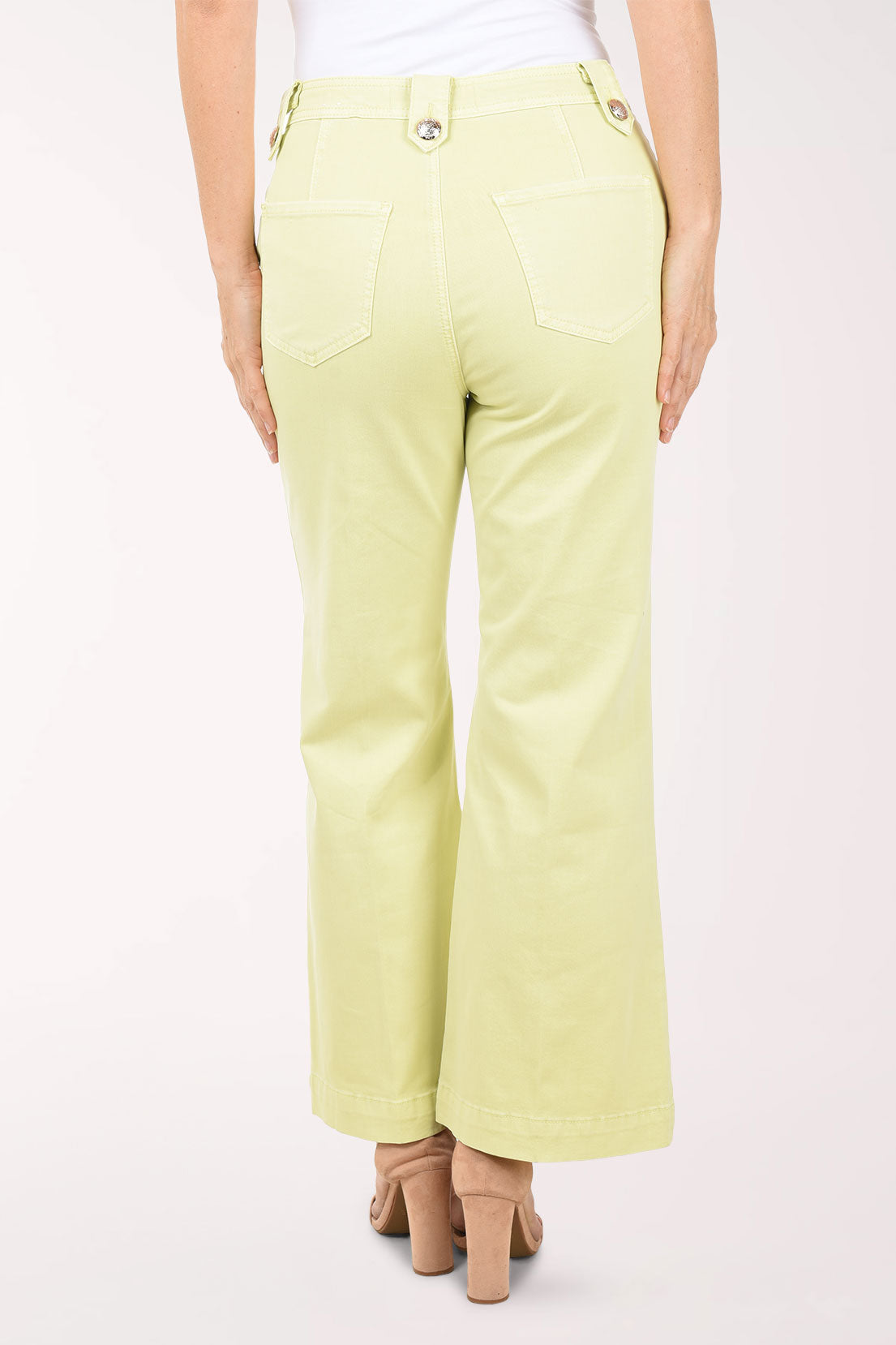 Light green pants worn by a person on a white background