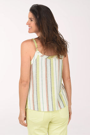 Woman wearing a striped sleeveless top and light green pants on a white background