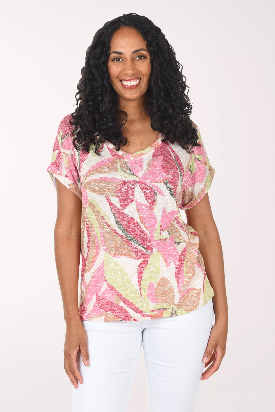 Woman wearing a pink floral top on a white background