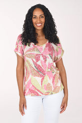 Woman wearing a pink floral top on a white background