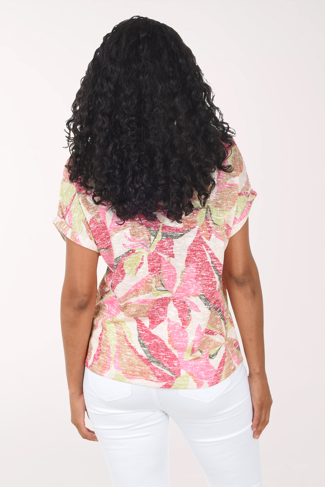 Woman wearing a pink floral top on a white background