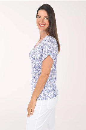 Woman wearing a blue floral patterned shirt on a white background
