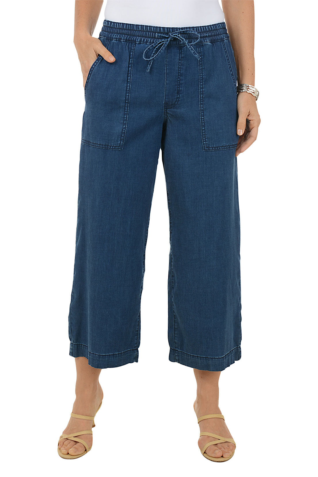 Blue denim pants worn by a person on a white background