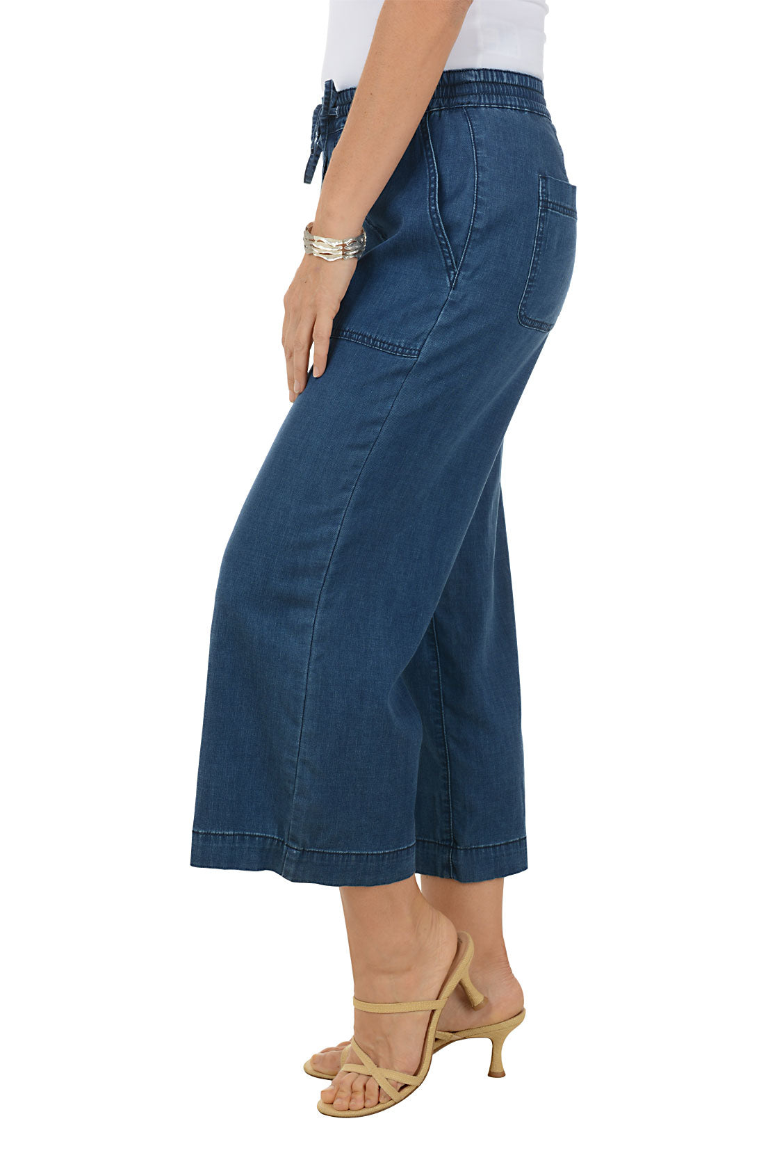 Blue denim pants worn by a person on a white background