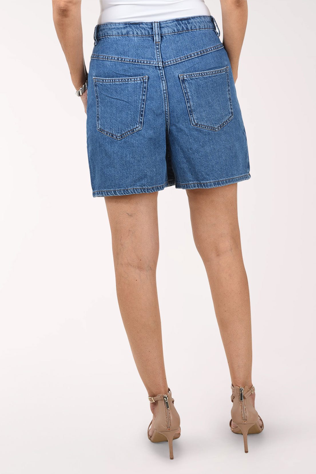 Person wearing a blue denim skirt on a white background