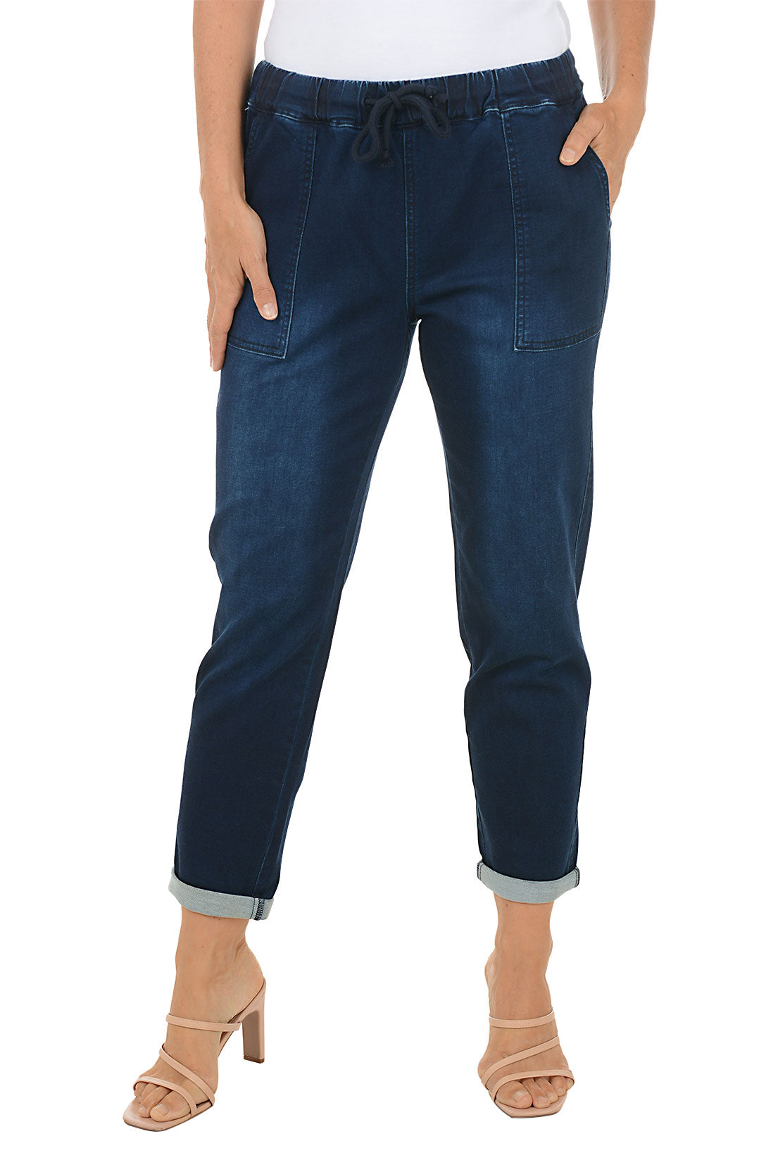 Person wearing navy drawstring blue pants with a white background.