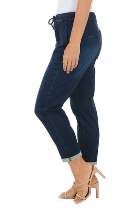 Person wearing navy drawstring blue pants with a white background. Side shot.