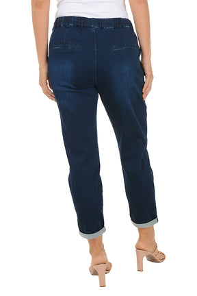 Person wearing navy drawstring blue pants with a white background. Back shot.