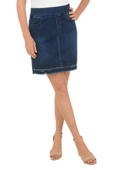 Person wearing a blue denim skirt on a white background.