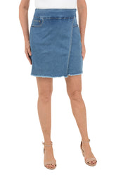 Denim skirt worn by a person on a white background.
