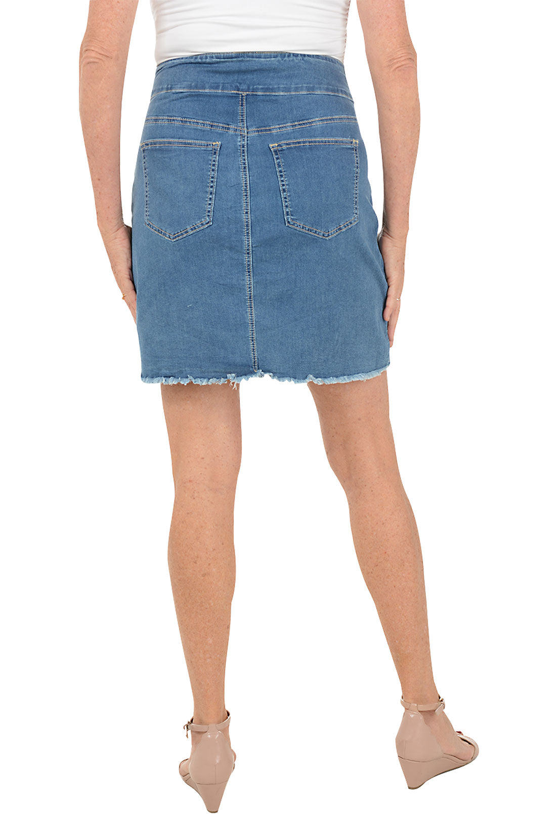 Denim skirt worn by a person on a white background. Back shot.