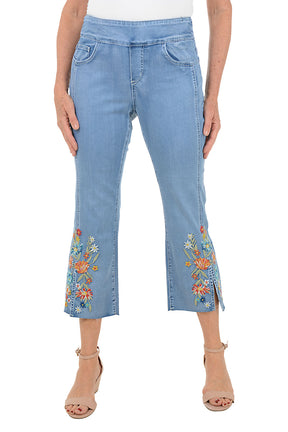 Light blue jeans with floral embroidery on a white background.
