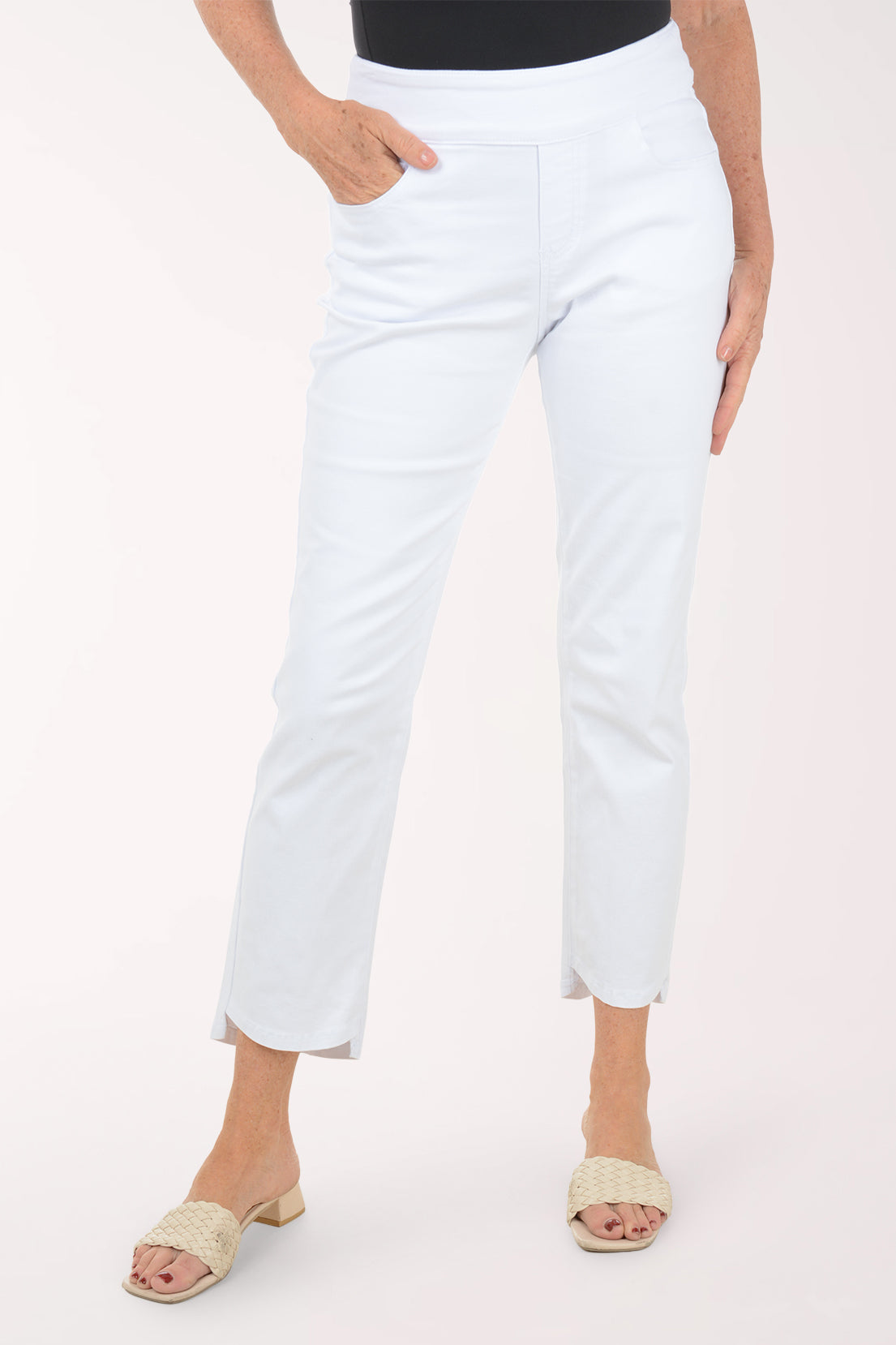 Front view of the White Denim Stepped Hem Ankle Pant showing the wide pull-on waistband, front pocket and curved stepped hem at the ankle.