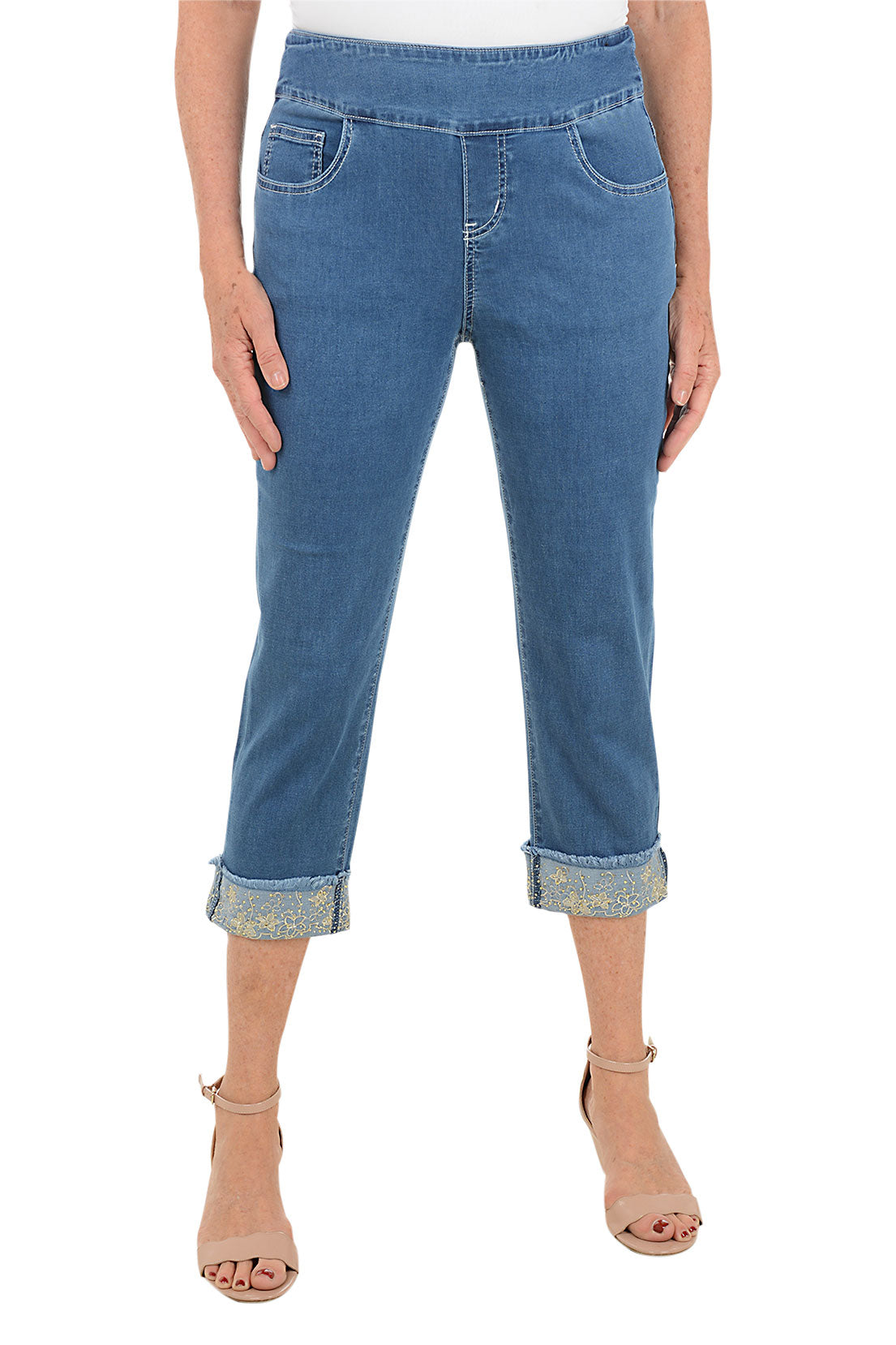 Blue jeans worn by a person on a white background.