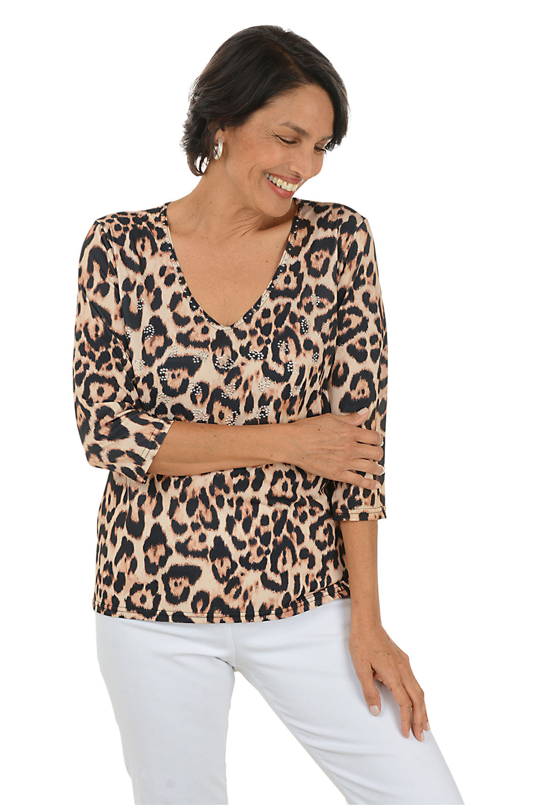 Woman wearing a leopard print top and white pants on a white background.