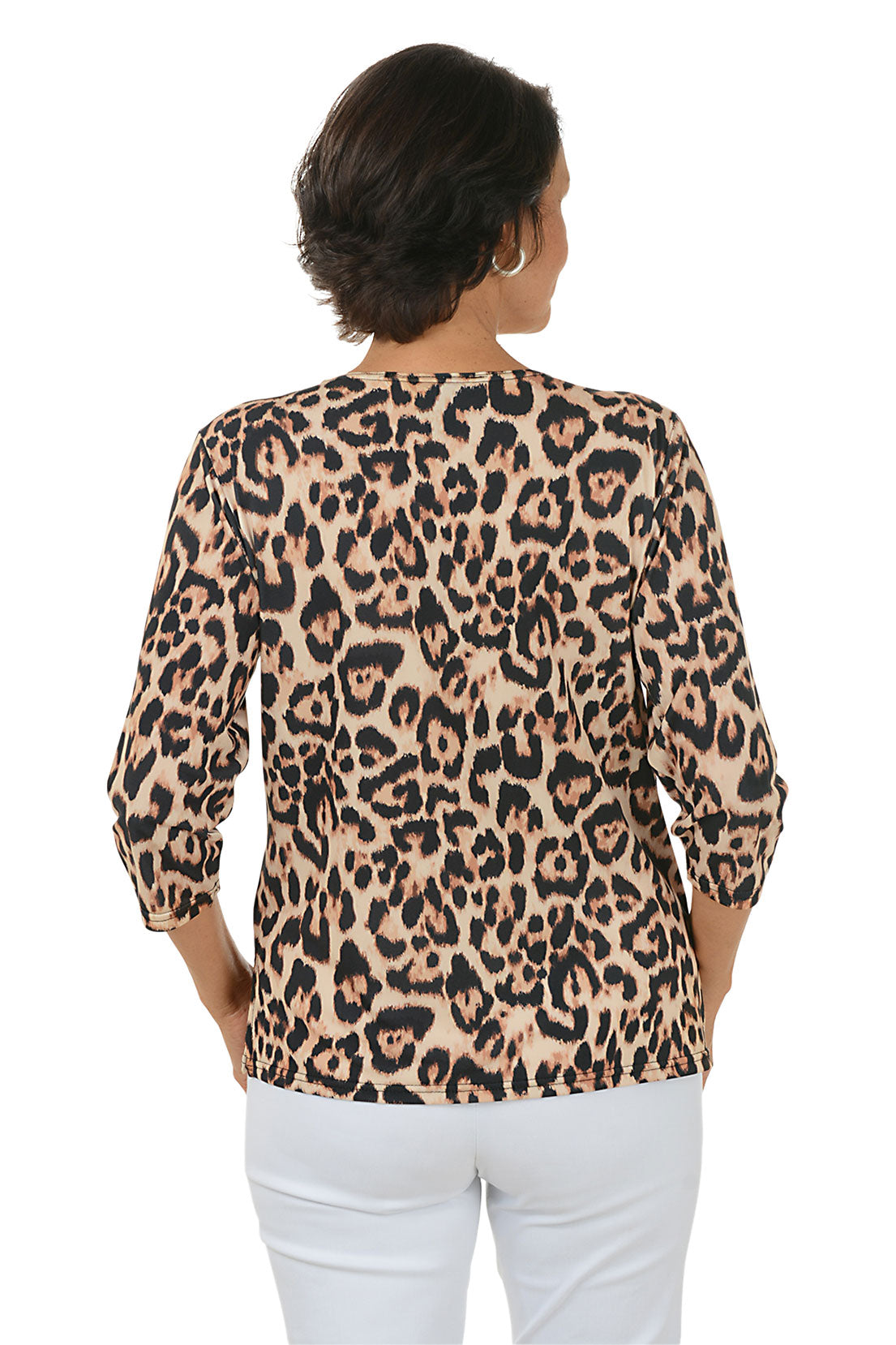 Woman wearing a leopard print top and white pants on a white background. Back shot.