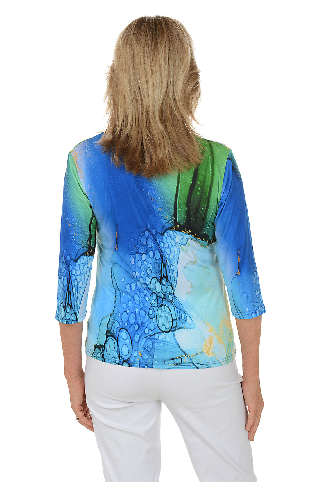 Woman wearing a colorful abstract patterned top on a white background. Back shot.