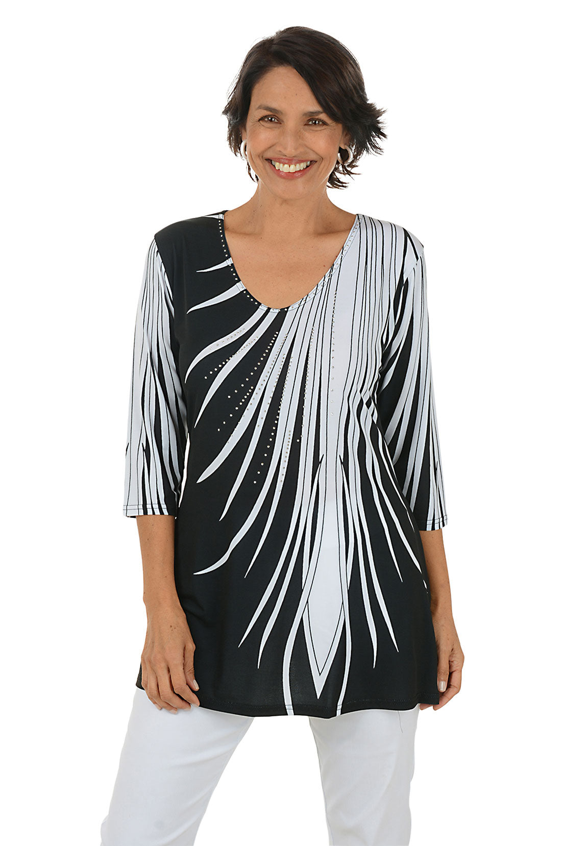 Woman wearing a black and white patterned top on a white background.